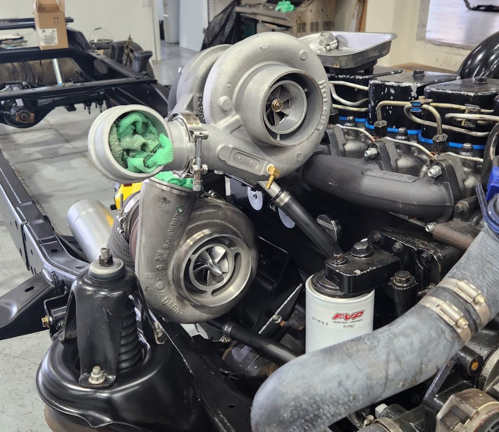 a Holset and BorgWarner compound (twin) turbocharger setup installed on a Cummins diesel engine