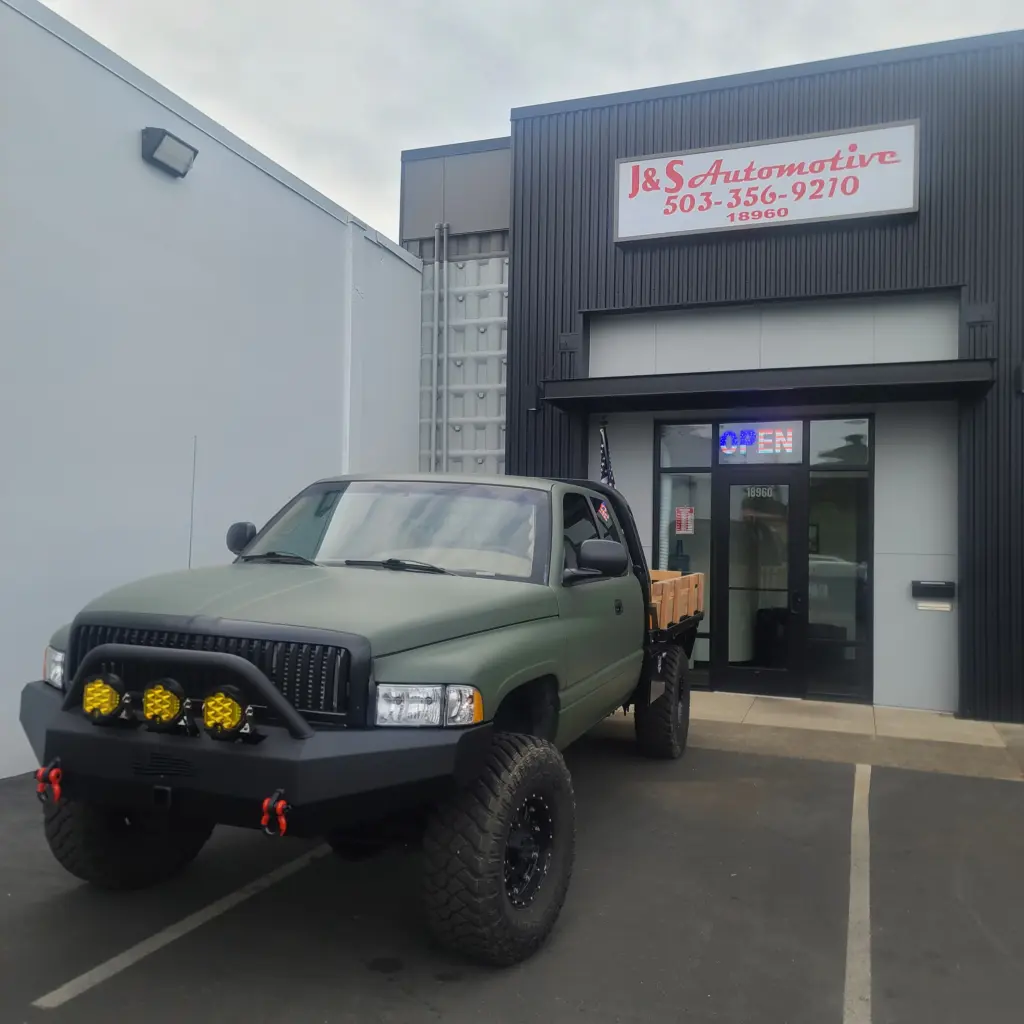 truck featuring a custom green flat paint job parked in front of J&S Automotive