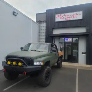 truck featuring a custom green flat paint job parked in front of J&S Automotive