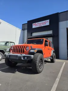 orange Jeep parked at J&S Automotive